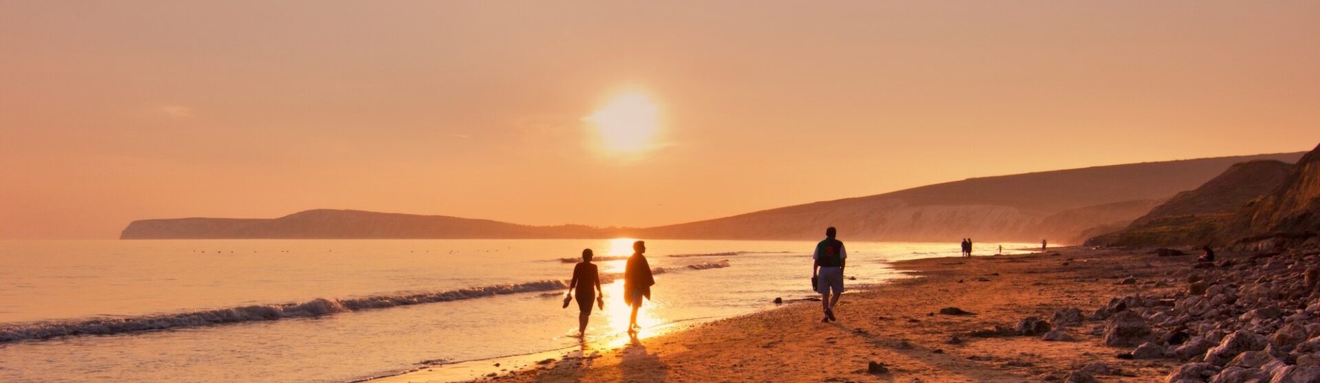 Walkers on Shanklin beach at sunset