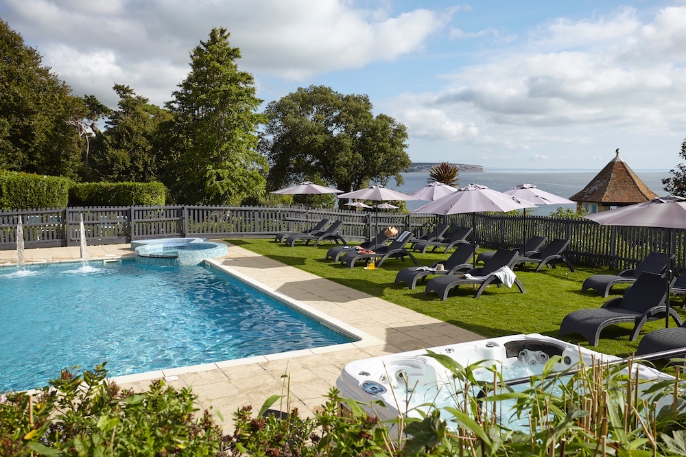 The outdoor swimming pool at Luccombe Manor above the sea