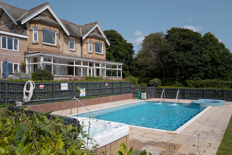 Luccombe Manor and its outdoor pool on a summer day